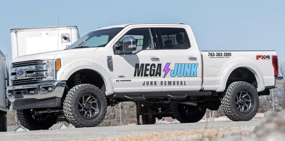 MEGAJUNK junk removal truck in Coon Rapids, MN, lettered with the lightning-bolt logo and 763-303-2091